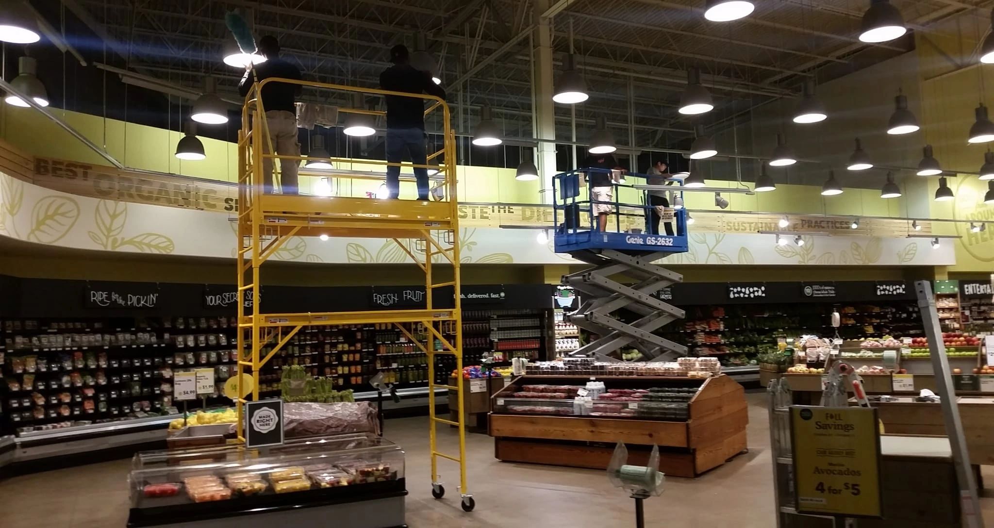 Using scissor lifts and scaffolding to high dust a grocery store